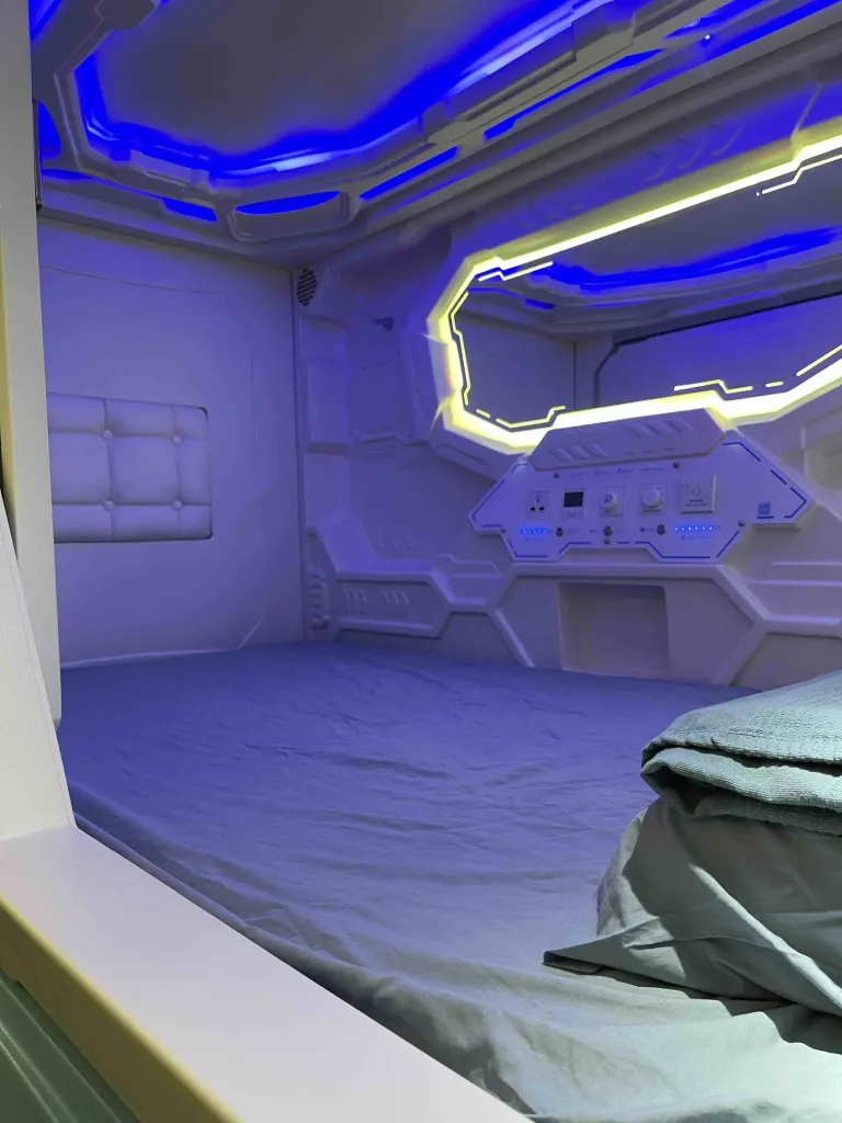 Modern Japanese-style capsule pod interior at Pelangi Hostel Johor Bahru with personal lighting and privacy curtain