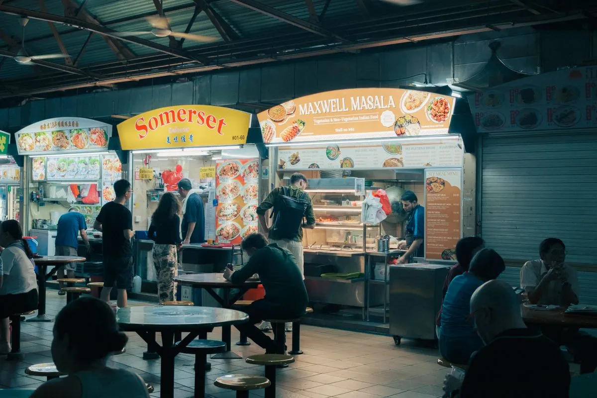 Night market stalls at Pasar Karat Johor Bahru with vintage goods, street food, and crowds of shoppers