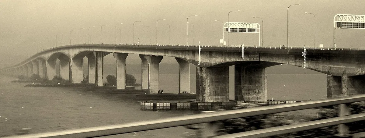 The Second Link bridge between Johor and Singapore, a long concrete viaduct over the Tebrau and Tuas waters in sepia tones