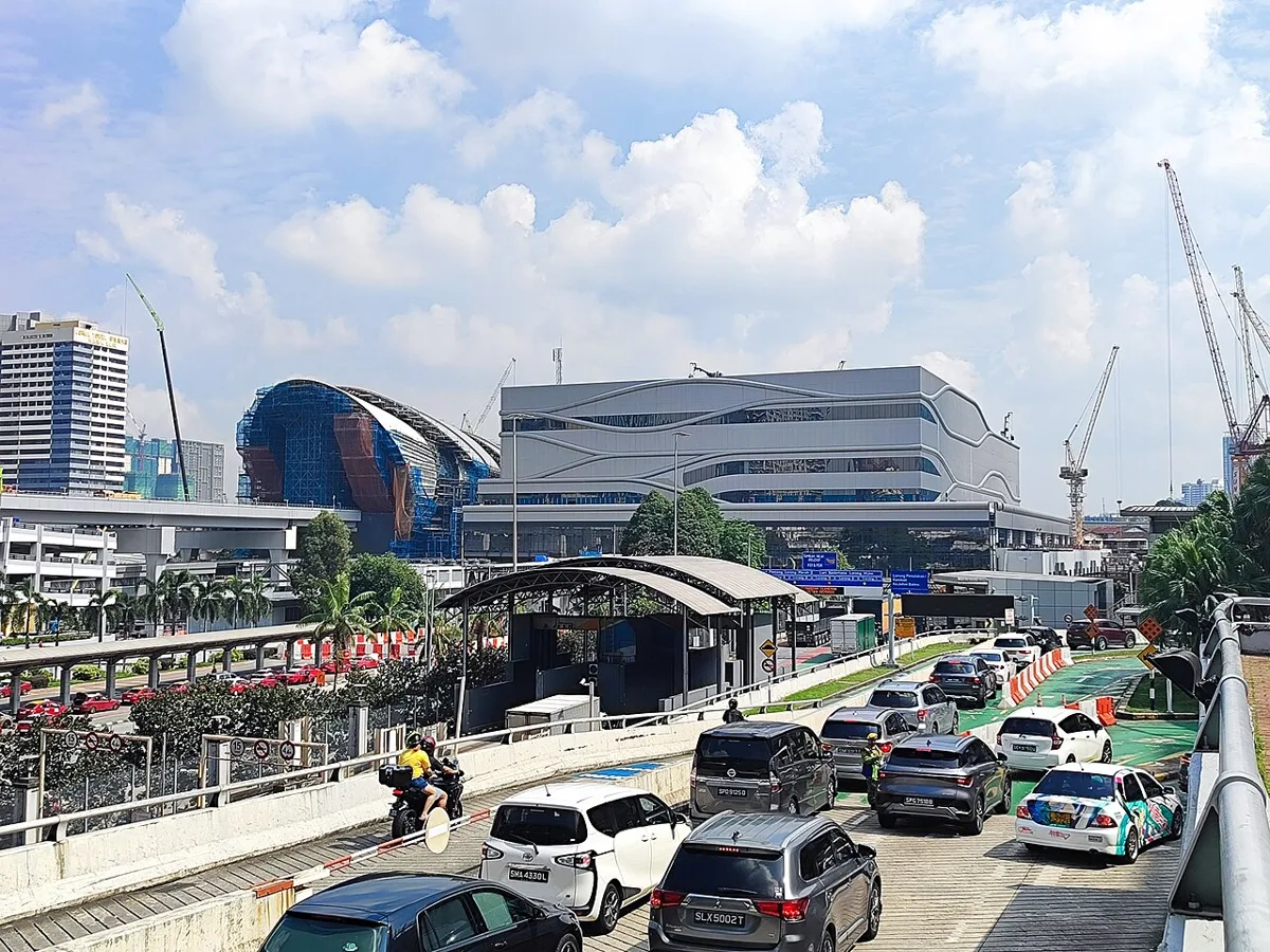 The Bukit Chagar RTS Link station building in Johor Bahru under construction in June 2026, seen above vehicles queuing on the approach road