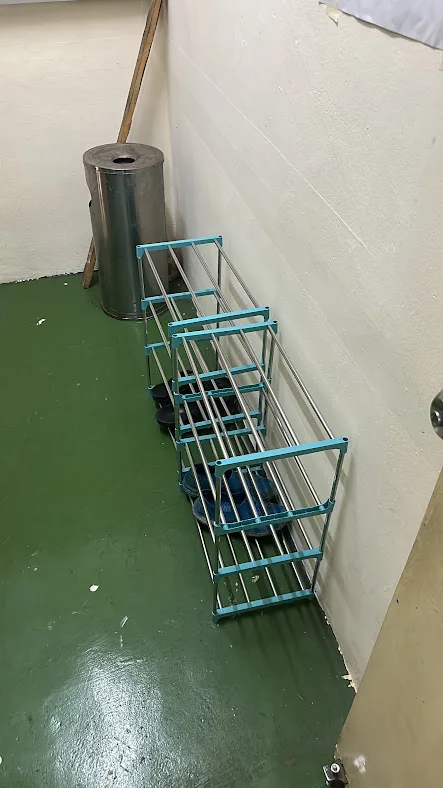 Shoe storage rack at the entrance of Pelangi Capsule Hostel